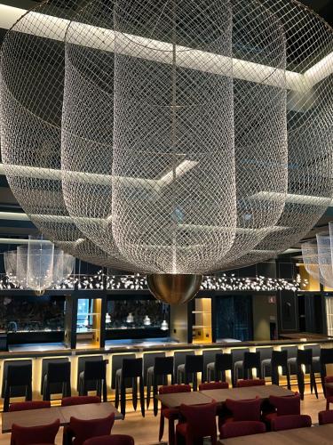 a large white net chandelier in a restaurant at Art Legacy Hotel Baixa-Chiado in Lisbon