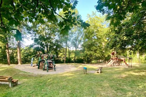 a park with a playground with play equipment and benches at Krahnberghaus Gotha - Ferien mitten in Deutschland in Gotha