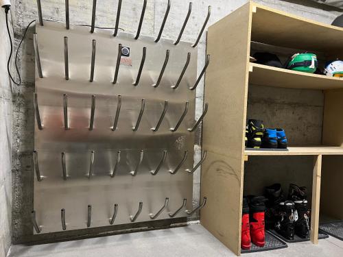 a metal garage door with hooks on a shelf at Casa Capricorn in Davos