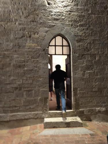 a man walking through an arch in a stone wall at Azienda Agrituristica I Tre Casali in Magione