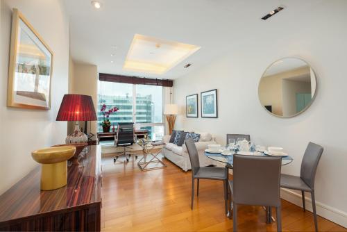 a living room with a table and a couch at Sky Villas Apartments in Bangkok