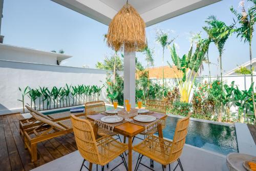a dining room with a table and chairs and a pool at Villa Zahka - 1BR Private Luxury Hideaway near Seseh Beach in Canggu