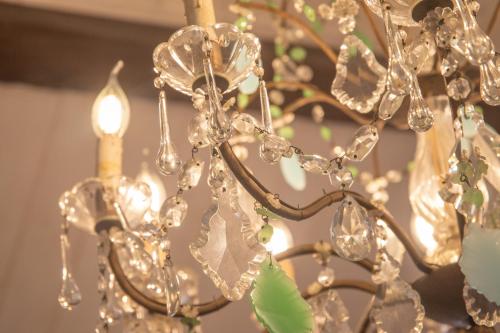 a close up of a gold chandelier at La Casetta. Feel at home. in Castelfidardo
