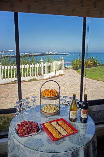 a table with food and bottles of wine on it at Sea & Sand Inn in Santa Cruz