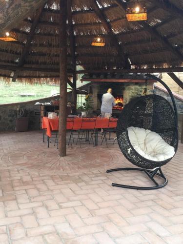 a chair in a pavilion with a table and a man at Azienda Agrituristica I Tre Casali in Magione