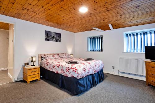 a bedroom with a bed and a tv in it at Finest Retreats - Woodstock Lodge in Bishop Middleham