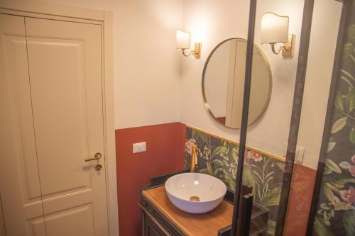 a bathroom with a sink and a mirror at La Casetta. Feel at home. in Castelfidardo