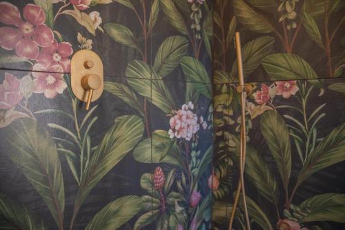 a wall with a painting of flowers on it at La Casetta. Feel at home. in Castelfidardo