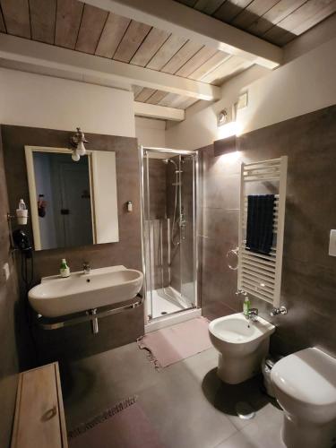 a bathroom with a sink and a toilet and a shower at Malvasia room in Brindisi