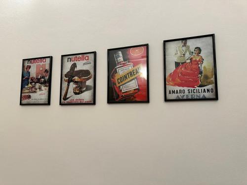 a group of framed pictures on a wall at Le Tre Ca', Ca' Cecilia, Ca' Nina, Ca' Vittoria in Asti