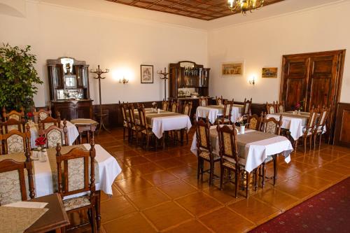 a restaurant with tables and chairs in a room at Penzión Kúria in Dolný Kubín