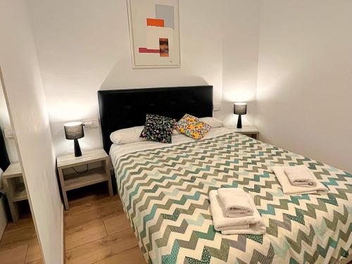 a bedroom with a bed with pillows on it at Apartamento cerca de la playa in Blanes