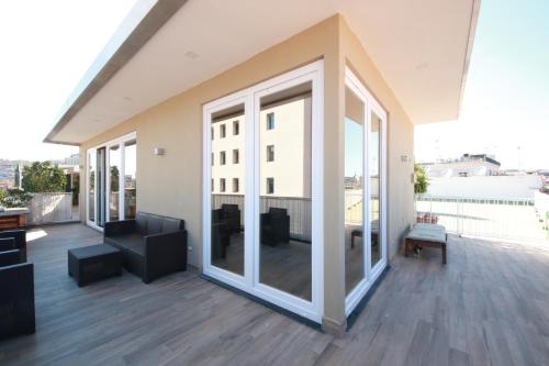 a balcony with sliding glass doors on a building at Talismano Luxury Suite & Loft & Alcova in Naples
