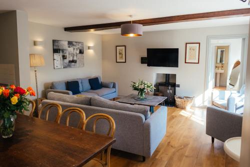 a living room with a couch and a table at Greenwood Grange in Dorchester