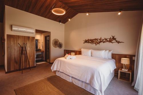 a bedroom with a large white bed in a room at Pousada Moana in Fernando de Noronha