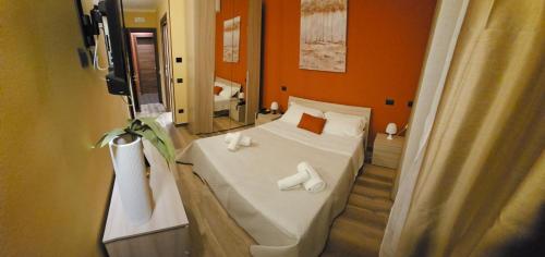 a bedroom with a bed with two towels on it at HOTEL BIJOUX in Pozzolo Formigaro