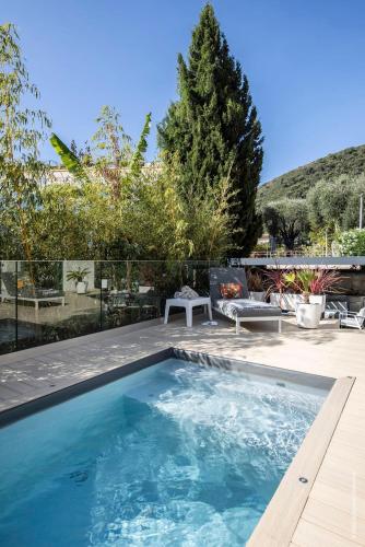 a swimming pool in the backyard of a house at Deluxe VILLA GRAZIELLA 200 M FROM THE BEACH in Èze