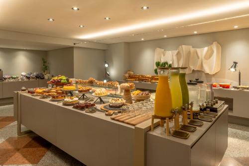 a buffet line with many different types of food at Laghetto Stilo São Paulo in Sao Paulo