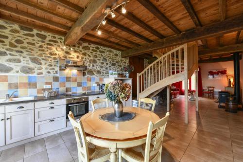a kitchen and dining room with a table and chairs at La bourdenabo in Lasseubetat