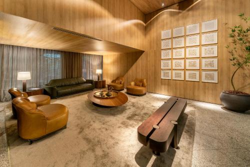 a living room with a couch and a table at Laghetto Stilo São Paulo in Sao Paulo