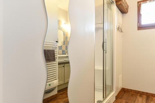 a white surfboard leaning against a wall in a room at La bourdenabo in Lasseubetat