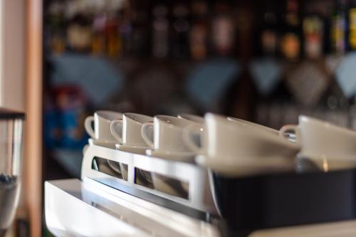a row of dishes sitting on top of a counter at Penzión Kúria in Dolný Kubín