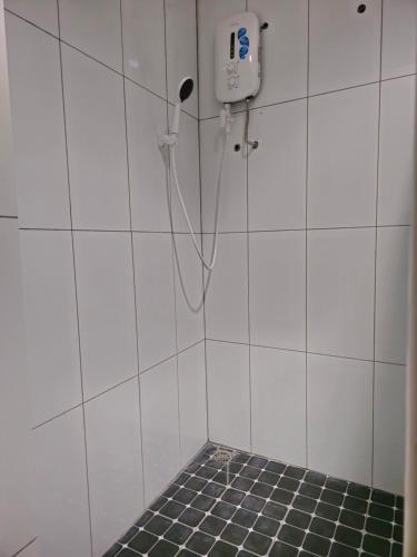a bathroom with a shower with a phone on the wall at 乔治市世纪酒店 The Century Boutique Hotel George Town in George Town