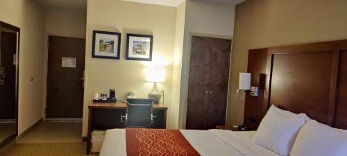 a hotel room with a bed and a desk at Comfort Inn Lancaster at Rockvale in Lancaster