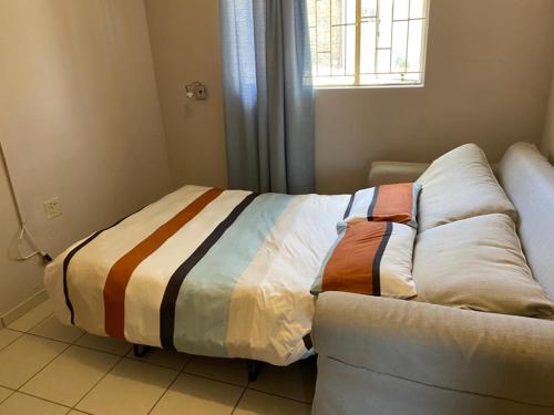 a bed sitting on a couch in a room at Kappsfarm Guesthouse in Voigtland