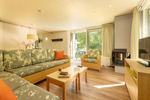 a living room with a couch and a table at Center Parcs Limburgse Peel Limburg-Brabant in America