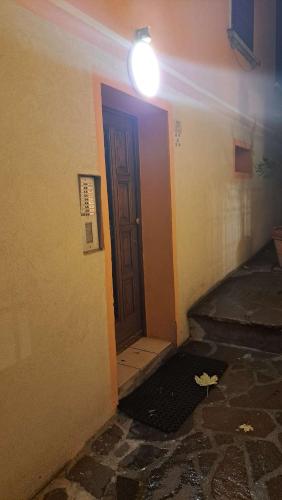 a room with a door and a light on a wall at OLD VILLAGE Apartment in Ponte di Legno