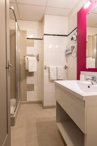 a bathroom with a sink and a shower at Splendid Hôtel in Paris