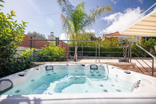 a hot tub in the backyard of a house at Pithea Luxury Living in Koroni