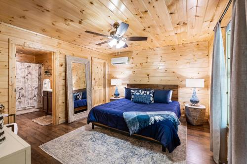 a bedroom with a bed and a ceiling fan at Brand New Luxury Cabin-Private Appalachian Retreat in Gatlinburg