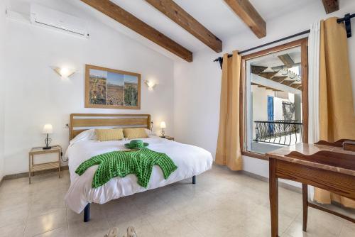 a bedroom with a large bed and a piano at Duplex flat in the old town of Alcudia in Alcudia