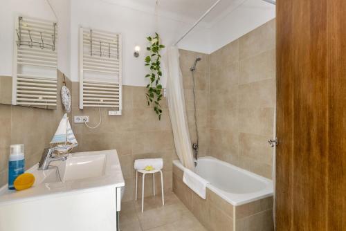 a bathroom with a sink and a bath tub at Duplex flat in the old town of Alcudia in Alcudia