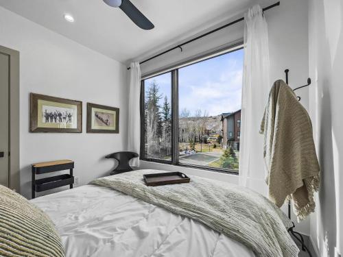 a bedroom with a bed and a large window at 541 Center Circle 3Br 3,5Ba townhouse in Silverthorne