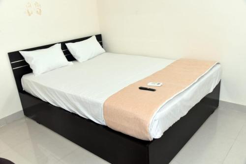 a bed in a room with a black and white mattress at Hotel Swagat Lodge in Nānded
