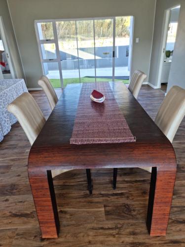 a dining room table with chairs and a table and a table and chairs at Lilitha Boutique Hotel-East London in East London