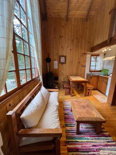 a living room with a couch and a table at Green Baker Lodge in Puerto Bertrand