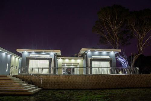 a house with lights on the front of it at night at Lilitha Boutique Hotel-East London in East London