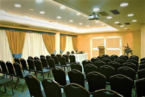 a conference room with chairs and a podium in it at Savoy Hotel in Piraeus