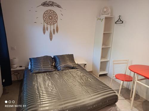 um quarto com uma cama e um relógio na parede em Ecoutez les oiseaux em Lunel