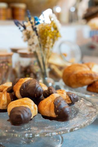 a glass plate with chocolate covered pastries on a table at Hostal el Ranxo in Cadaqués