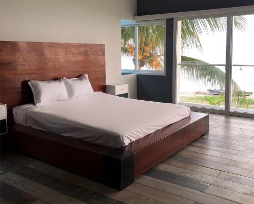 ein großes Bett in einem Schlafzimmer mit einem großen Fenster in der Unterkunft Sofy House, San diego, La Libertad in La Libertad