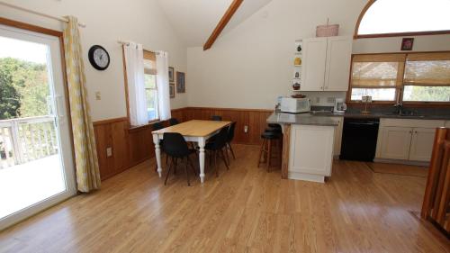 a kitchen with a table and chairs in a room at Oceanside, 5 BRs, Dog Welcome, Close to Shopping, SCH132, Sue's Seahouse in Duck