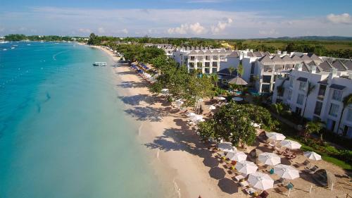 an aerial view of a beach with umbrellas and buildings at Azul Beach Resort Negril, Gourmet All Inclusive by Karisma in Negril