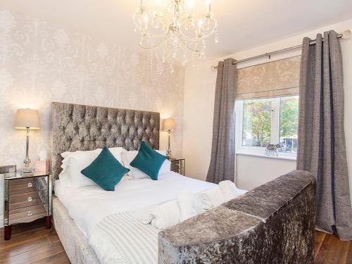 um quarto com uma cama grande e um lustre em Holgate Lodge em York