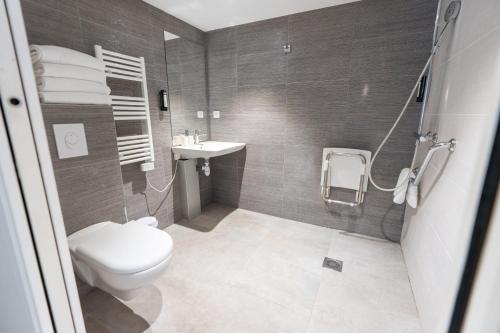 a bathroom with a toilet and a sink at Kyriad Résidence Cabriès - Plan de Campagne in Cabriès
