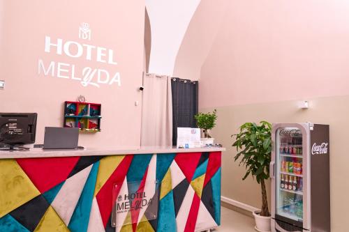a hotel meloda counter in a room with a soda machine at Hotel Melydà in Pozzuoli
